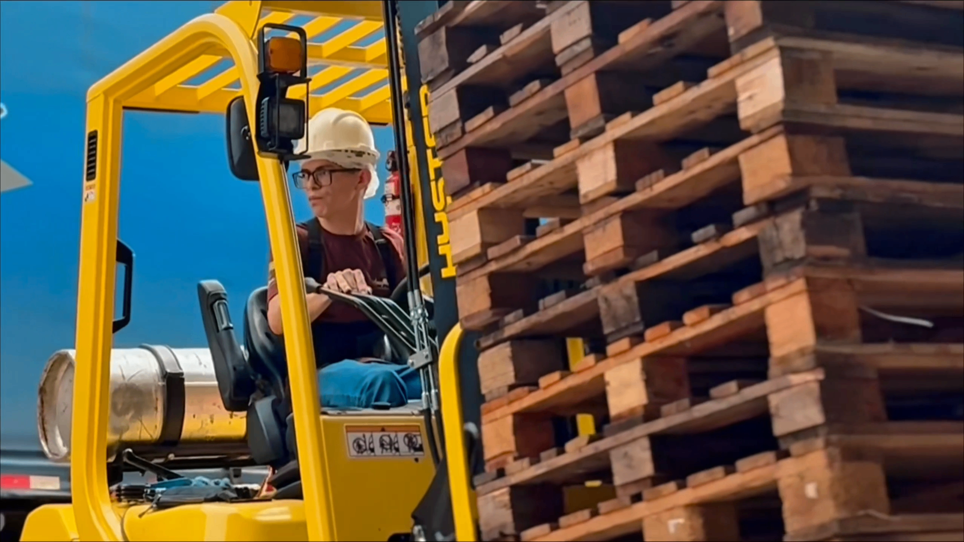 Operador de empilhadeira movimentando pallets na usina